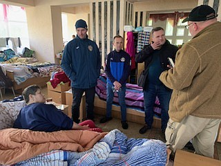 Ernest DeSoto of Sheridan recently spent time in Ukraine doing his part to help the people there through a mission trip. Pictured here DeSoto (far right) and his team members visit an evacuee with stage IV cancer about palliative care while the team was in L’viv.