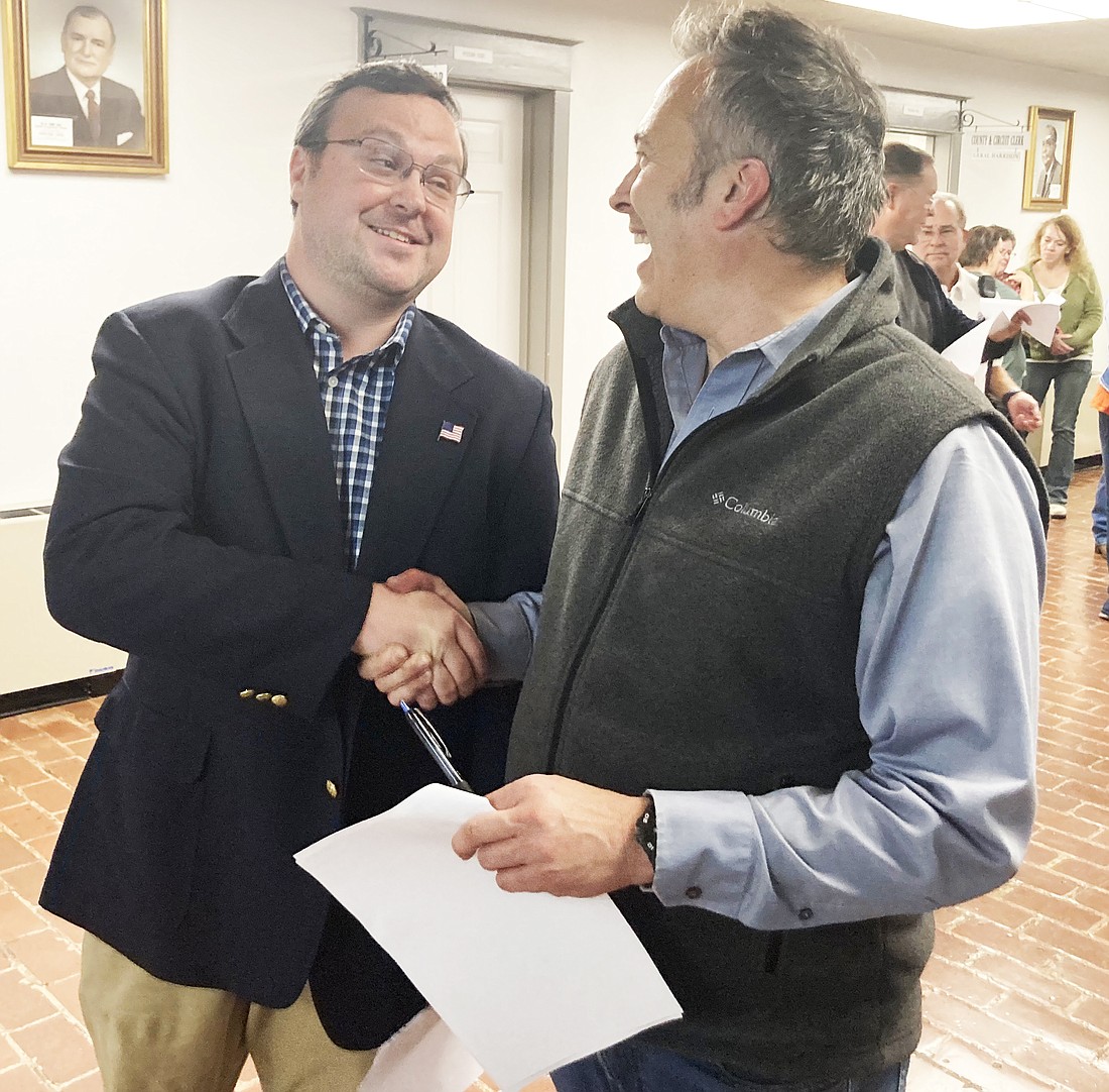 Cain Nattin is congratulated by fellow candidate Justin Wise after run-off election results showed Nattin as the winning candidate in the run-off election for Sheridan's next mayor, a position left open after the retirement of longtime mayor Joe Wise.