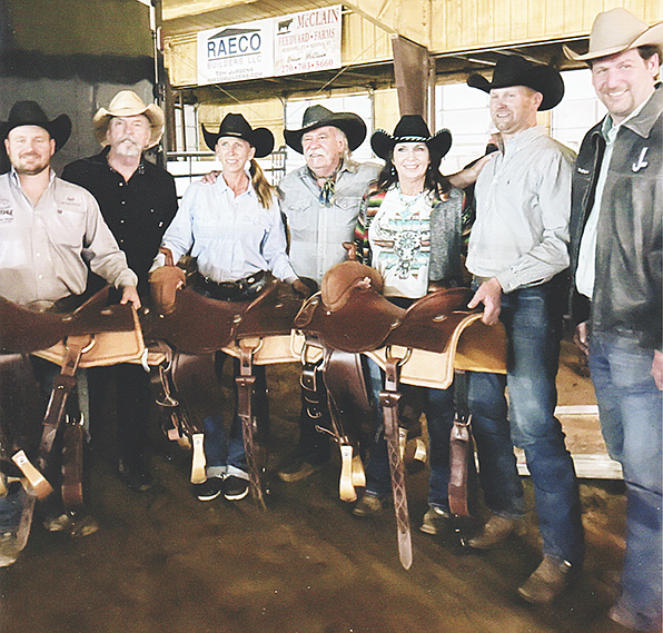 Janeice Allen (third from right) recently won first place in team pinning at the JL Shootout in Whitesboro, Texas. The Bellomy Brothers were on hand to help present awards at the event and sign the prize saddles awarded to first place winners.