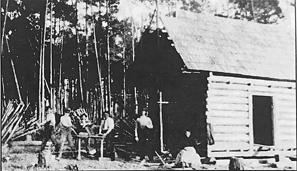 These men are assembling the framework for a mud and stick chimney. Photo Courtesy of the Grant County Museum