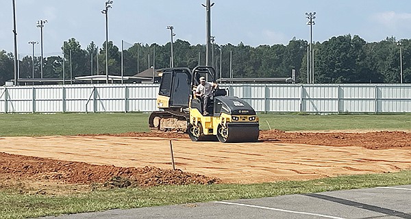 SHERIDAN BROKE GROUND on a new pickleball court last week at the Sheridan Sports Complex area across from the Sheridan Recreation Center. The new pickleball court will be located adjacent to the soccer field and fishing pond. Photo By Gretchen Ritchey