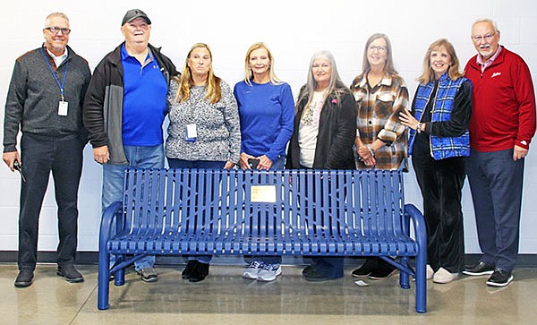 The Sheridan High School Class of 1976 recently placed a memorial bench in the SHS gym in memory of their classmates who have passed before them. Pictured are (L to R) SHS Principal Blaine Alexander, and SHS Class of 1976 members Mike Griffith, Vicki Strong, Jeanne Gartman, Audrey Smith, Pattie Lites, Marylin Easley, and Randy Williams.