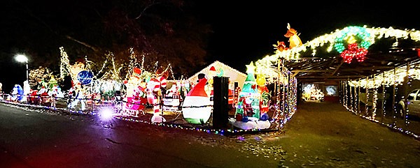 WILLIE AND JO CARTER of Sheridan enjoy spreading the joy of holidays with their yard displays. Locals know the home on Brenda Drive in Sheridan well whether it be for this beautiful Christmas display or the Carter’s Halloween decorations and haunted house. Photo by Gretchen Ritchey