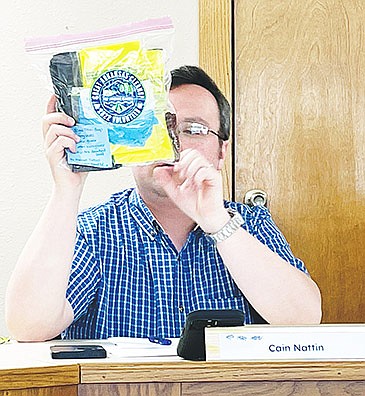 SHERIDAN MAYOR CAIN NATTIN shows the supplies available for the Adopt-A-Street program during a previous Clean City Taskforce meeting.