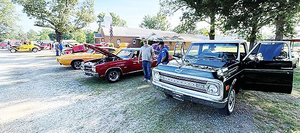 Guests enjoy viewing the many cars, trucks and motorcycles at the first Tull Car Show on Saturday, May 18 held by the Tull Fire Department at the Tull Community Center. Photo Submitted