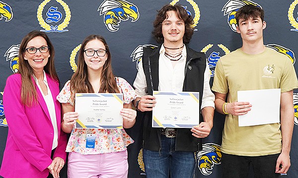 Heather Atchley, Carson Lyons and Blake Jimerson were recognized at the Sheridan school board meeting on Monday, Nov. 4. They were each selected as members of the Senator John Boozman Congressional Youth Cabinet for 2024-2025. Sheridan High School Principal Candace Wilson presented them with a “Yellowjacket Pride” certificate for their achievement. Each student also had an opportunity to tell meeting attendees about what their selection meant to them. Photo courtesy of Sheridan Schools Communications