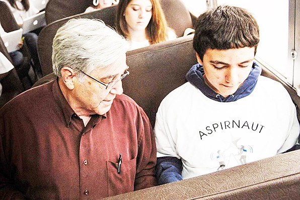 Dr. Billy Hudson, a Grant County native, discusses the Aspirnaut program with students on a bus ride.