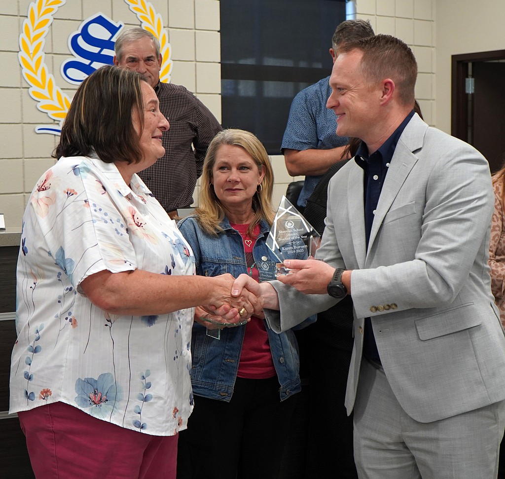 Karen Burnett, a teacher at Sheridan High School, was named Teacher of the Year for the Sheridan School District at last week's school board meeting. She is pictured here with Superintendent Chad Pitts and Lynn Summit with the Alternative Learning Academy. (Photo: Courtesy of the Sheridan School District)