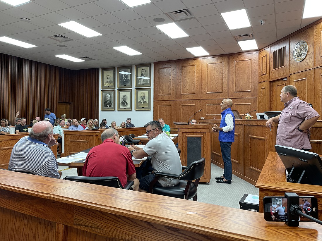Raj Keswani, president of Clean Cloud Energy, stands at the podium at the July Quorum Court meeting where he discussed a solar farm and data center his company wants to build. A lawsuit against the projects was dismissed on Tuesday, Sept. 9. (Photo: Grechen Ritchey)