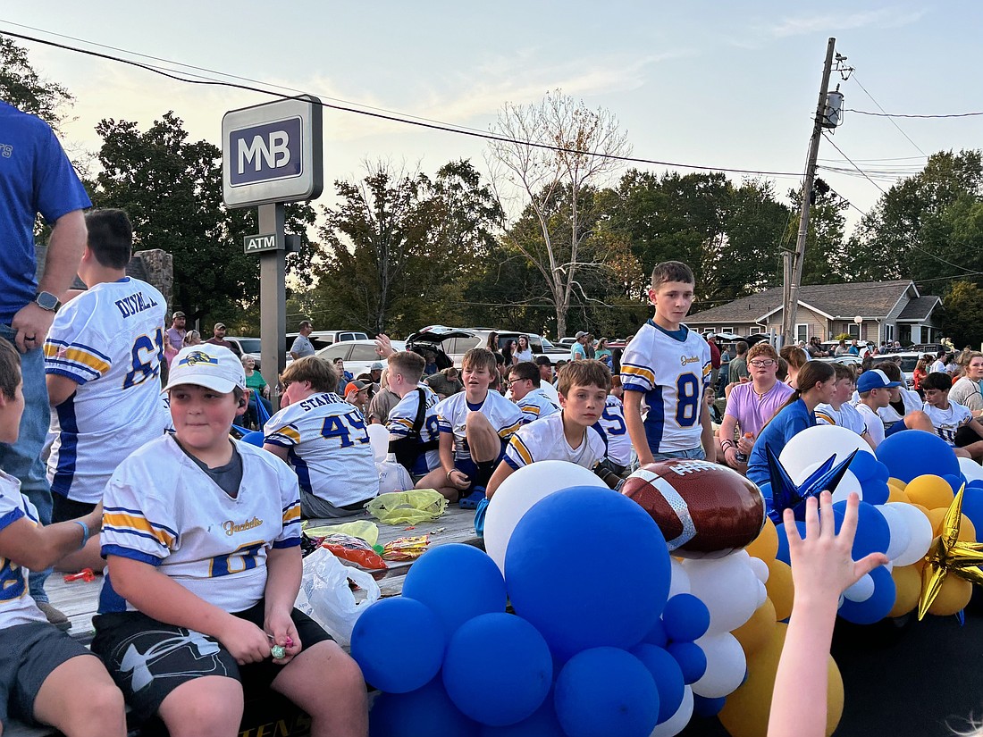 Football players enjoy themselves as they participate in the Grant County Fair Parade on Tuesday. (Special to The Headlight)