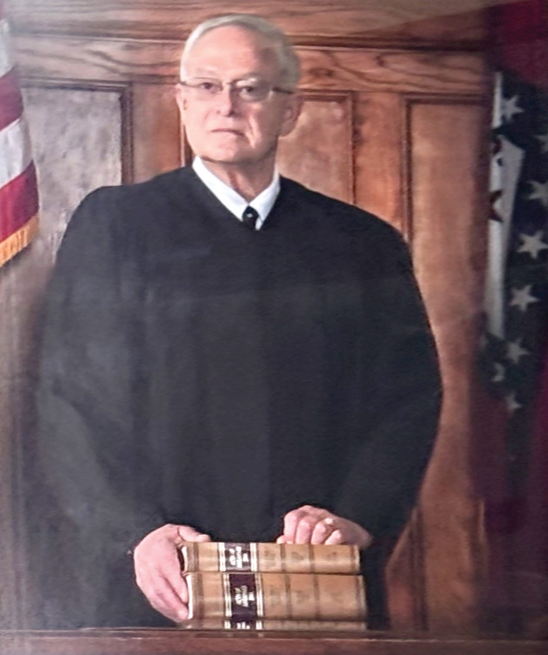 A portrait of former Circuit Judge Chris Williams shown here, now hangs with all of the other judges that served in the Hot Spring County Courthouse, although current Circuit Judge Stephen Shirron has expressed his dismay with the new addition. (Photo: Gretchen Ritchey)