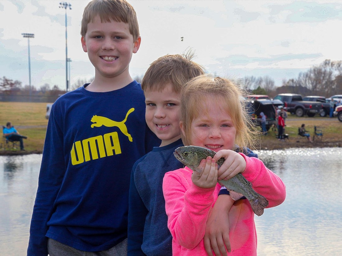THREE KIDS AND A FISH
Family and Community Fishing Program Locations will still have one stocking of rainbow trout this December. Shown here is the Trout Derby at Pleasant View Park Pond in Russellville. (AGFC image.)