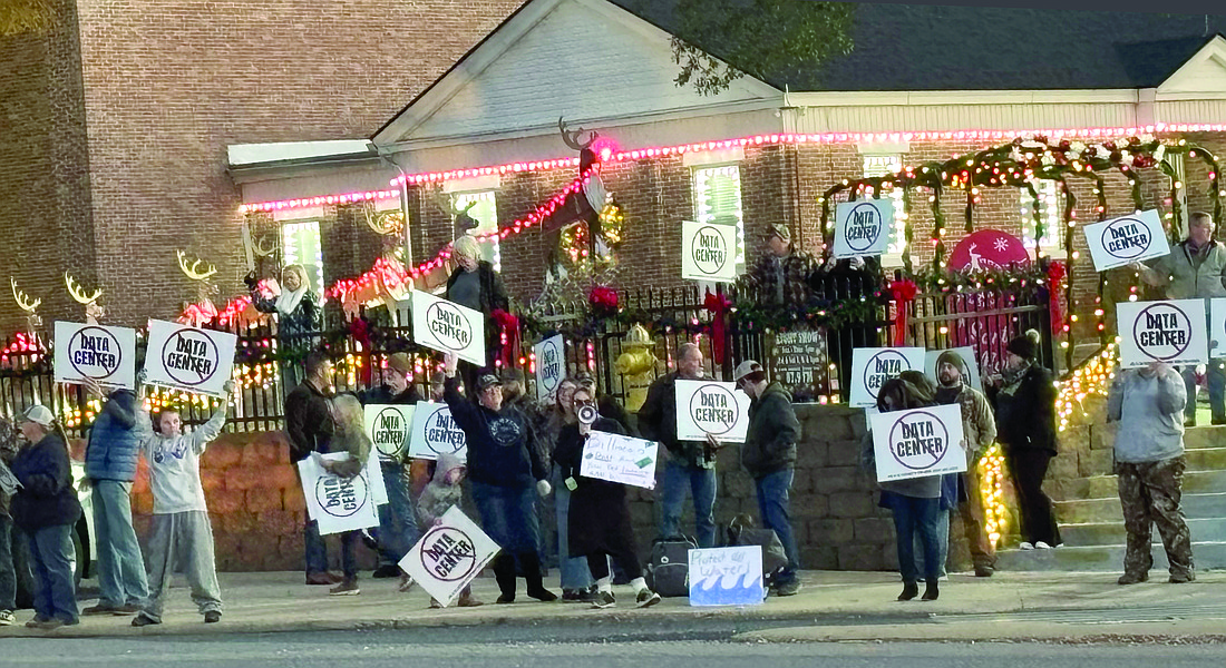 No DC protest. That was the sentiment of some 70 residents who gathered last Monday evening lining the streets in downtown Sheridan holding signs opposing a proposed Grant County data center.(Photo: Gretchen Ritchey)