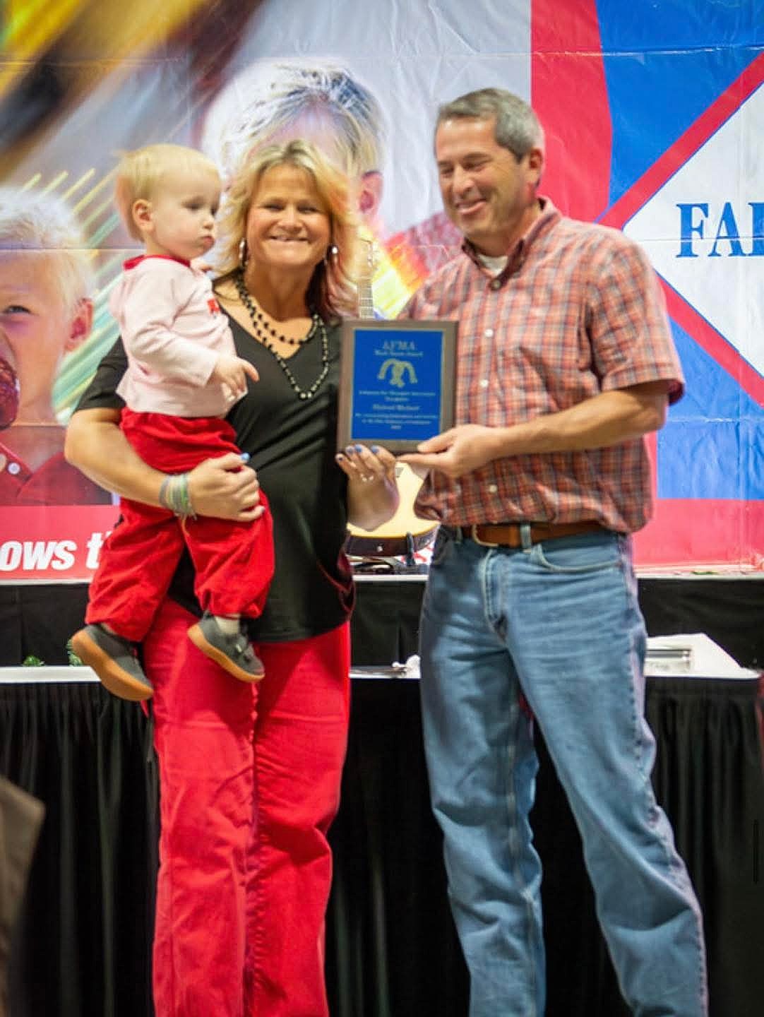 Mike Michael, president of the Grant County Fair Board, was honored recently for his work on the board. Shown here are Evan Michael, Michael's grandson, and Scharidi Barber, director.(Photo: Submitted)