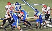 A SHERIDAN RUNNER follows his blocking to pick up yards last week against Jacksonville. The Yellowjackets fell behind early but came back to beat the Titans by a score of 27-20  